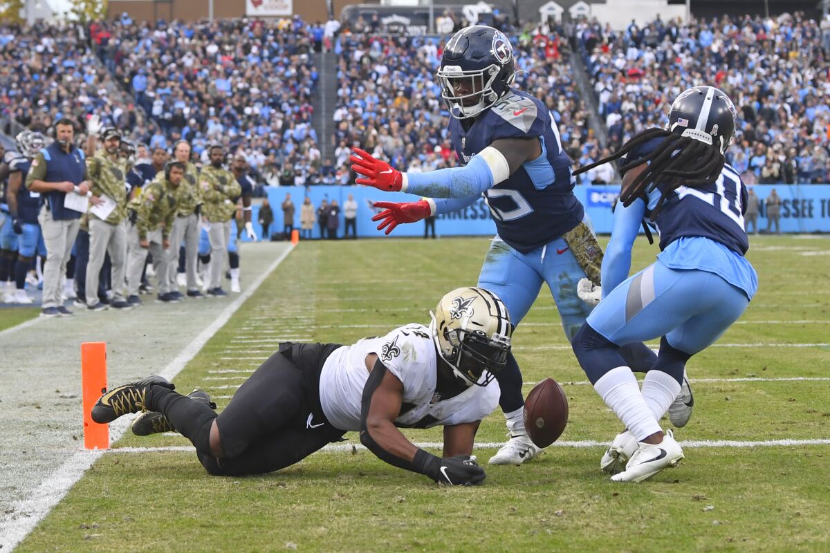 Tennessee Titans defenders Jayon Brown (55) and Jackrabbit Jenkins (20) break up a pass intended for New Orleans Saints running back Mark Ingram (14) on a 2-point conversion attempt late in the fourth quarter of an NFL football game Sunday, Nov. 14, 2021, in Nashville, Tenn. The play preserved the Titans' 23-21 win. (AP Photo/John Amis)