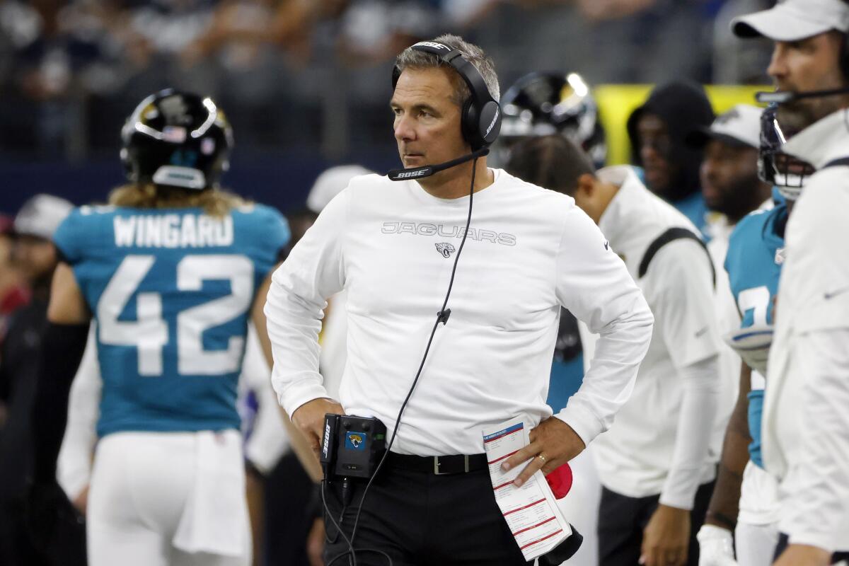 FILE - In this Sunday, Aug. 29, 2021, file photo ,Jacksonville Jaguars heads coach Urban Meyer, center, watches play in the first half of a preseason NFL football game against the Dallas Cowboys in Arlington, Texas. Meyer, unbeaten in season openers, will try to extend his 17-0 record when the Jaguars travel to Houston for their season opener. (AP Photo/Michael Ainsworth, File)