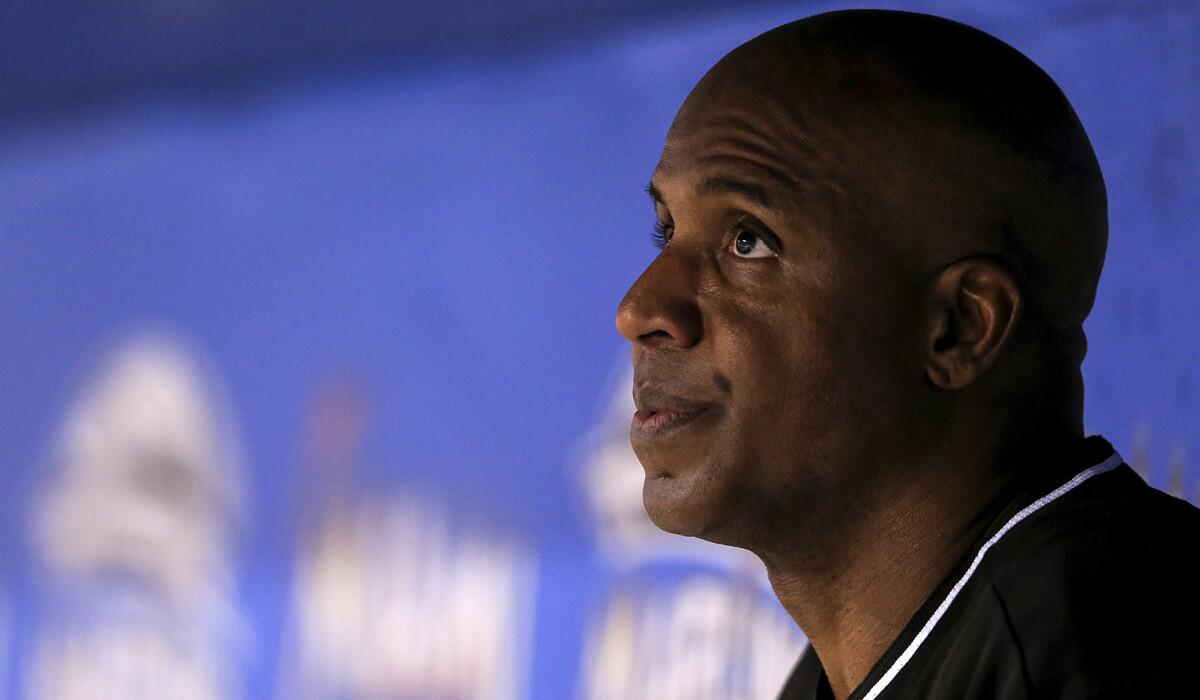 Former Miami Marlins hitting coach Barry Bonds looks on from the dugout during the seventh inning against the Atlanta Braves on Sept. 24.