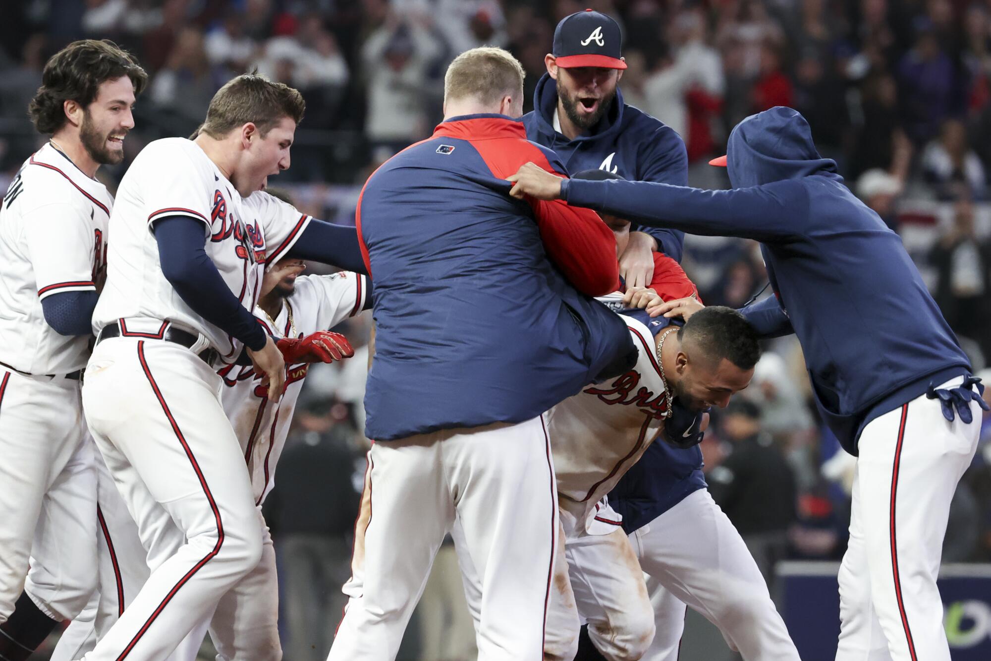 The Atlanta Braves celebrate Eddie Rosario's walk-off single to defeat the Los Angeles Dodgers 5-4 in game two