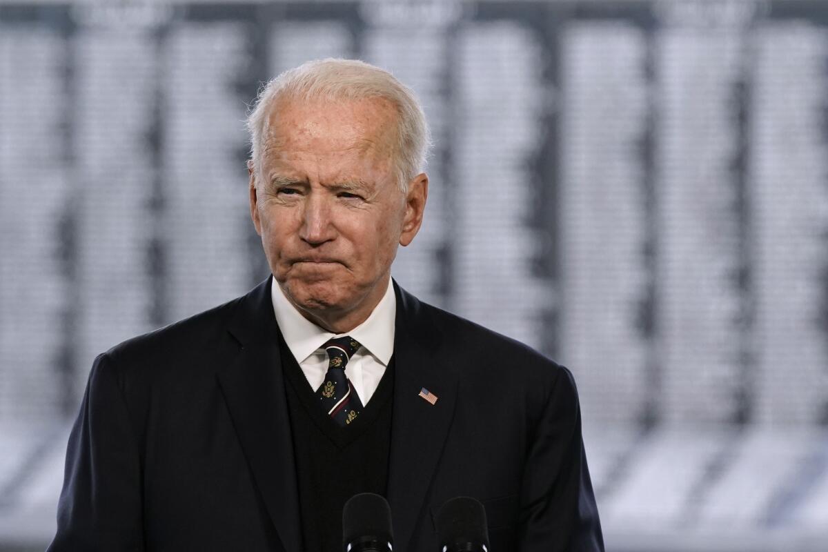 President Biden in a dark suit with a U.S. flag pin on it
