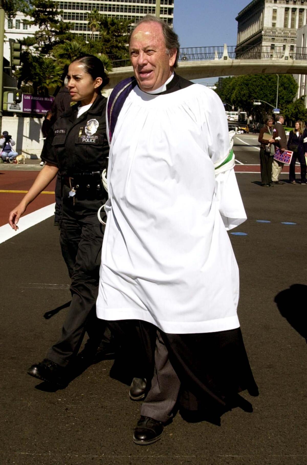 Los Angeles police arrest George Regas during a 2003 protest against the Iraq invasion.