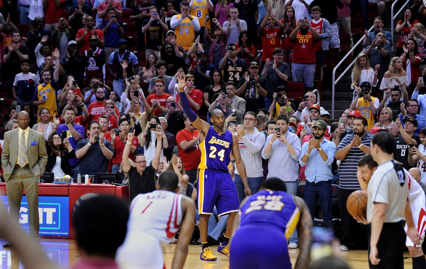 Kobe Bryant waves to the crowd as he leaves the court for the last time against the Rockets in Houston.