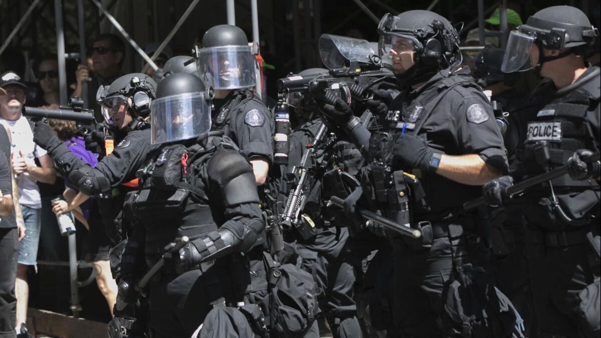 Police deploy flash-bang grenades during a rally in Portland, Ore., on Saturday.