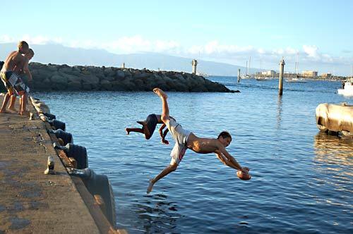 Near the end of of Lahaina on Maui, boys play at the boat ramp beside the bedragged Mala Wharf, which still suffers damages incurred during 1992's Hurricane Iniki.