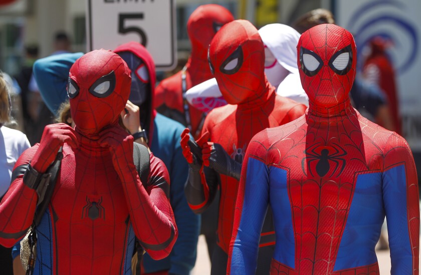 A group wearing Spider-Man costumes gather outside the San Diego Convention Center during Comic-Con International at on Saturday, July 20, 2019 in San Diego, California.