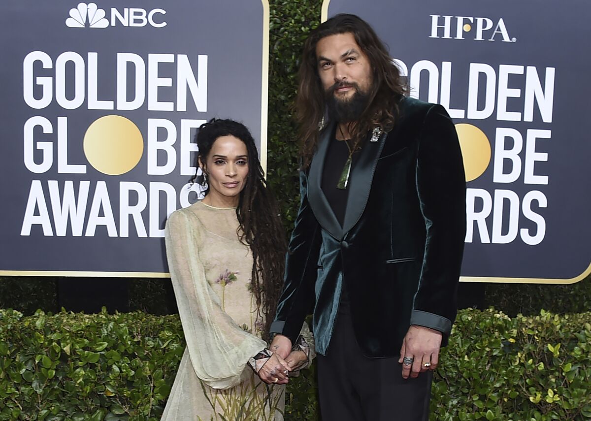 FILE - Lisa Bonet, left, and Jason Momoa arrive at the 77th annual Golden Globe Awards at the Beverly Hilton Hotel on Sunday, Jan. 5, 2020, in Beverly Hills, Calif. The couple have ended their 16-year relationship. A joint statement posted on the “Aquaman” star’s Instagram page Wednesday, Jan. 12, 2022, said that Momoa and his wife were parting ways. (Photo by Jordan Strauss/Invision/AP, file)