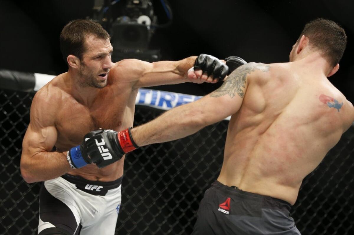 Fighters Luke Rockhold and Chris Weidman exchange blows during their middleweight bout at UFC 194 on Dec. 12.