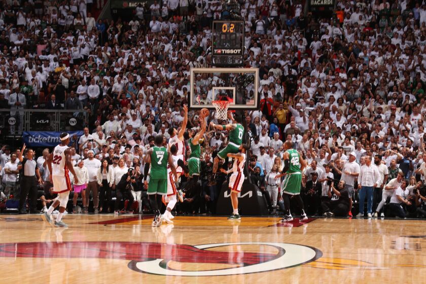 The Celtics' Derrick White tips in the winning basket against the Heat on May 27, 2023, in Miami.