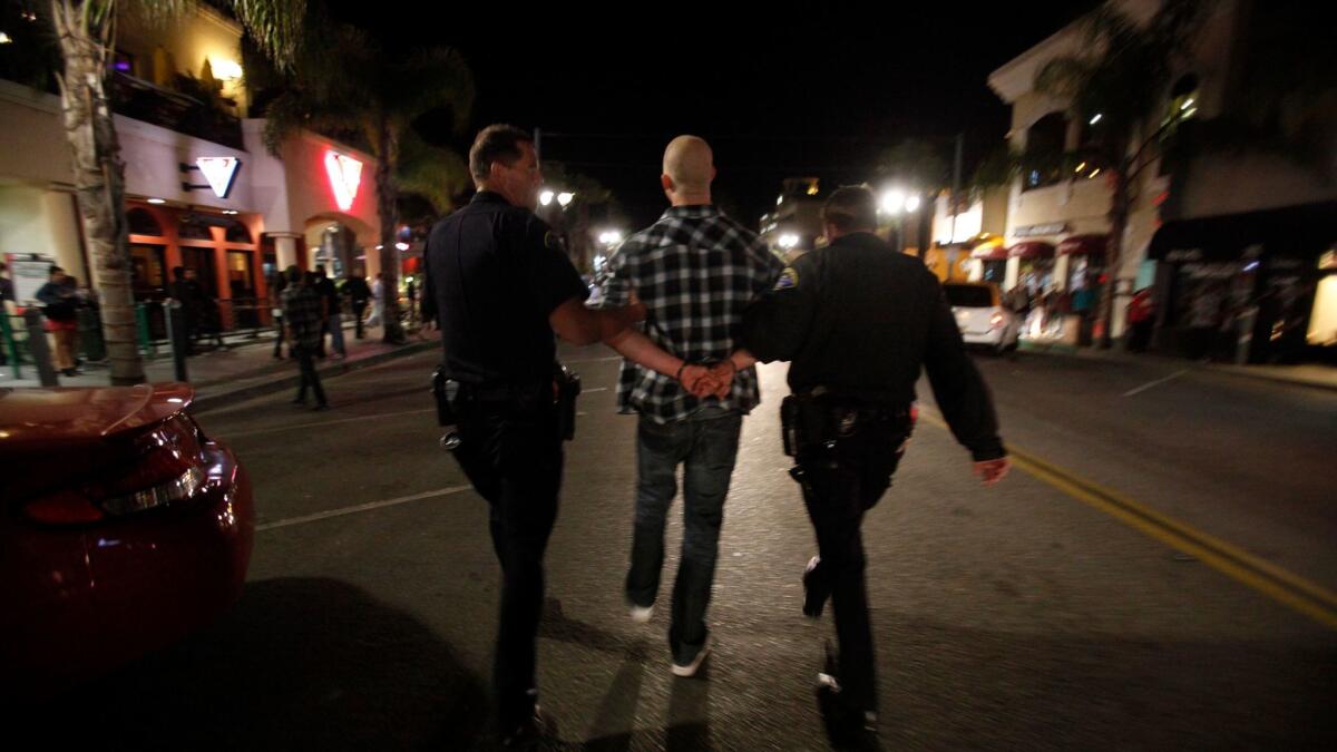 A man is arrested following a fight on Main Street in Huntington Beach.