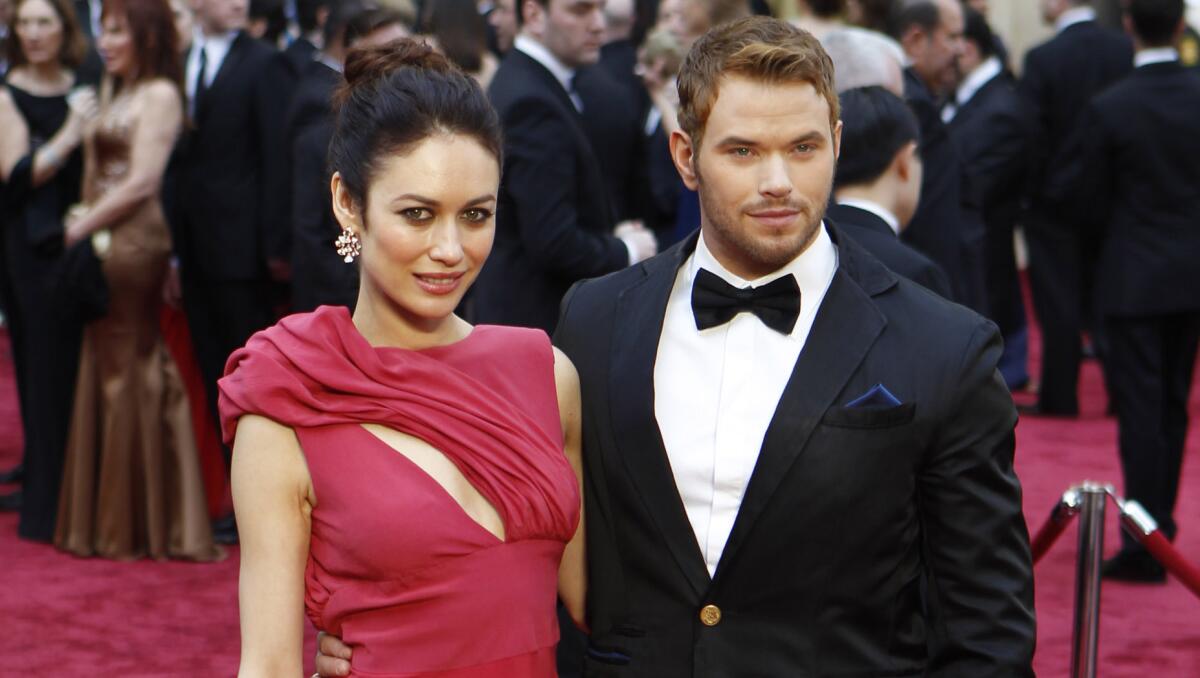 Olga Kurylenko, left, and Kellan Lutz arrive at the 86th annual Academy Awards last March, wearing eco-friendly attire chosen via the 2014 Red Carpet Green Dress contest. The deadline for submissions for the 2015 competition has been extended until Jan. 12.