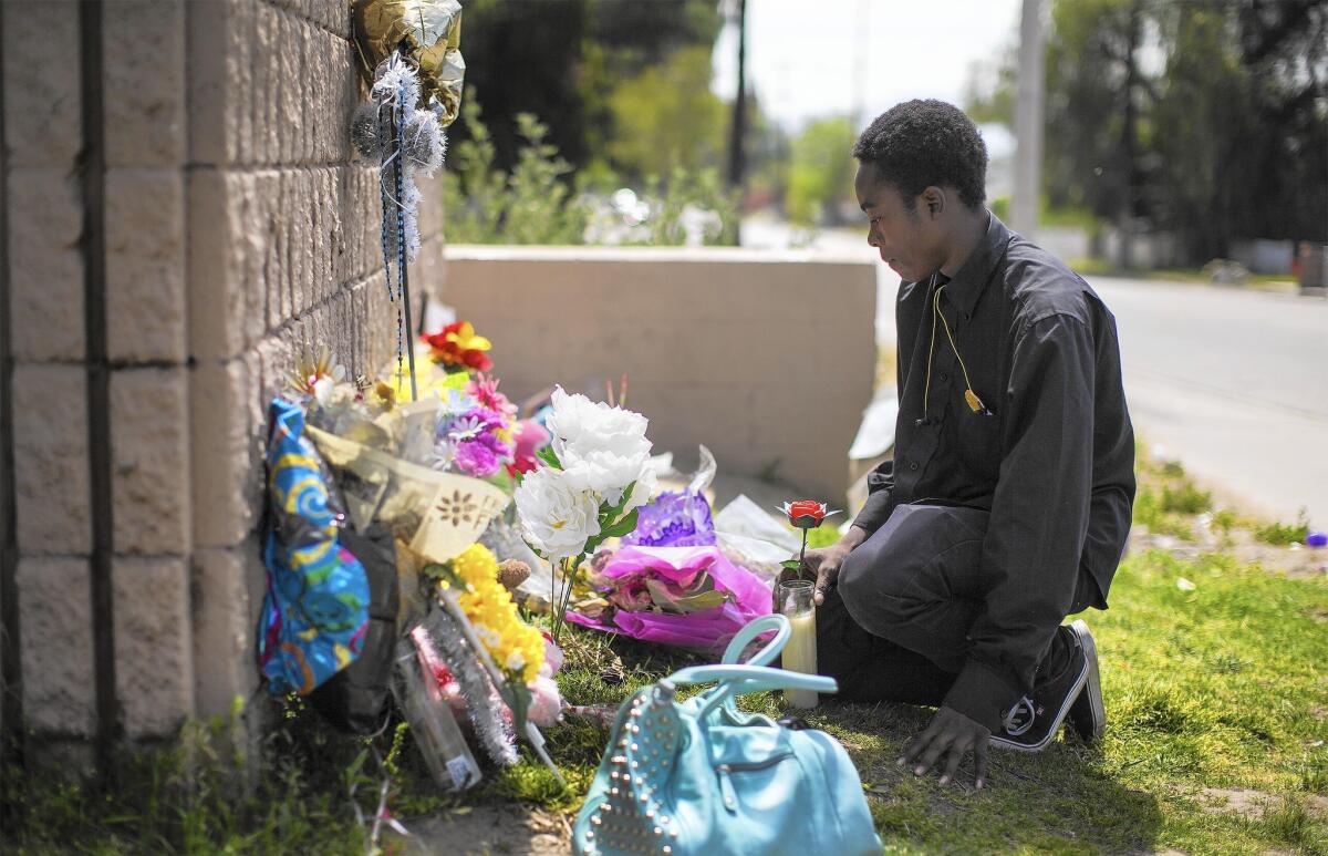Marqual Spears,19, visits a memorial at the site where his brother Jason was gunned down. The sixth-grader’s death marked the 15th homicide this year in a city already coping with economic struggles, persistent crime and the tragedy of last December's terrorist attack.