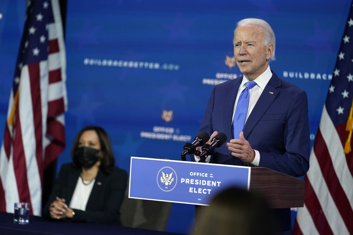 In this Dec. 1, 2020, photo, President-elect Joe Biden speaks as Vice President-elect Kamala Harris listens at left, during an event to introduce their nominees and appointees to economic policy posts at The Queen theater in Wilmington, Del. Up soon for Biden: naming his top health care officials as the coronavirus pandemic rages. It’s hard to imagine more consequential picks. Biden is expected to announce his choice to head the Department of Health and Human Services next week. (AP Photo/Andrew Harnik)
