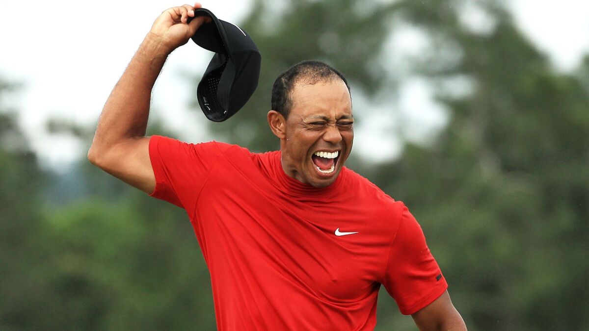Tiger Woods celebrates after winning the Masters on Sunday.