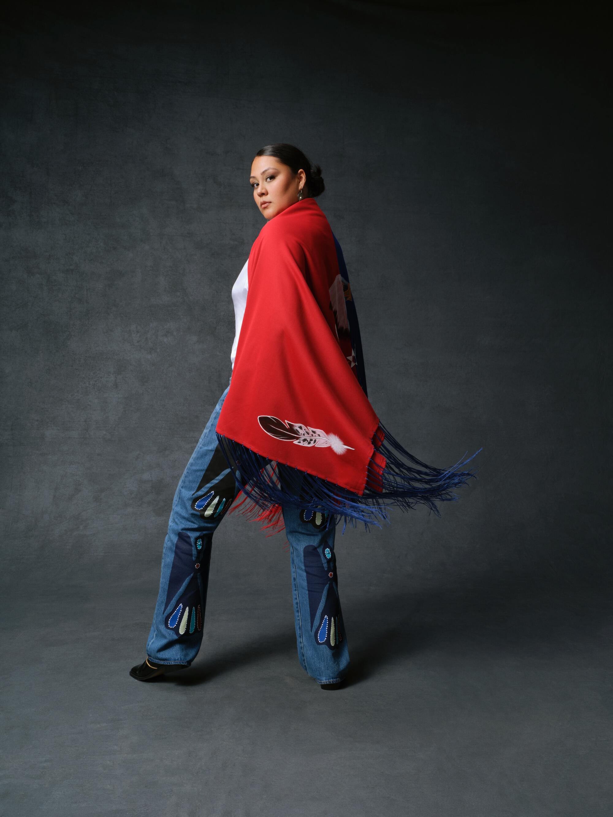A woman models embellished jeans from the collection.