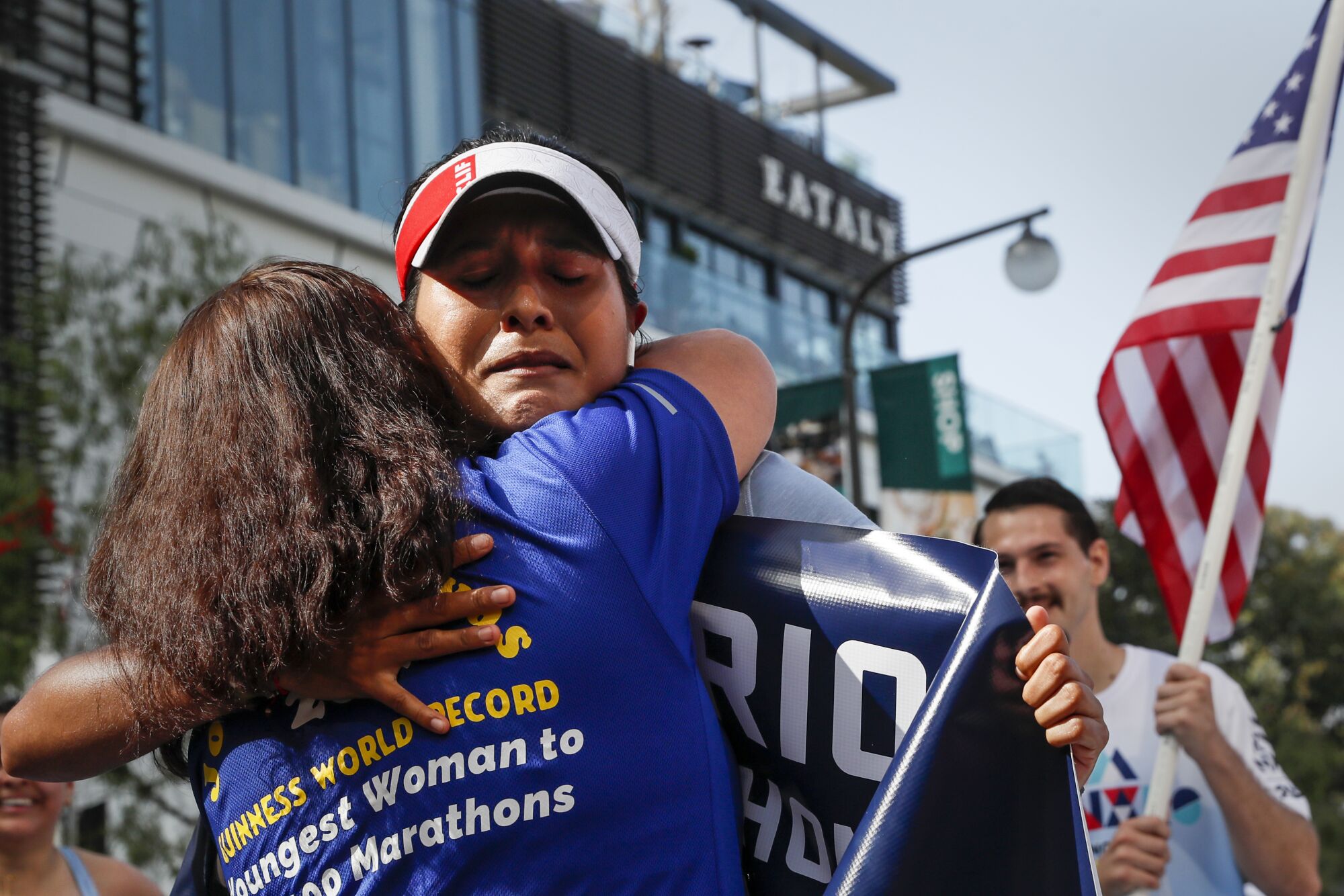 Jocelyn Rivas is hugged by her mother, Rosa at the finish line.