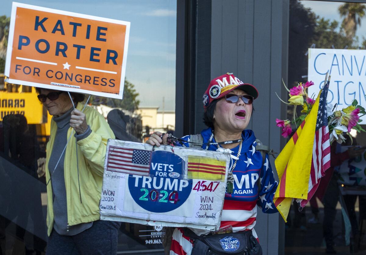 Victoria Cooper, right, yells as supporters depart a brief Rep. Katie Porter's rally on Saturday.