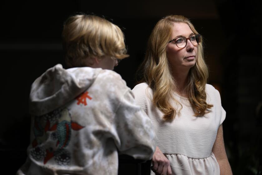 Becky Hormuth poses for a photo with her son Wednesday, Sept. 20, 2023, in Wentzville, Mo. About four years ago Hormuth's child, now a 16-year-old junior at a suburban St. Louis high school, came out as transgender. (AP Photo/Jeff Roberson)