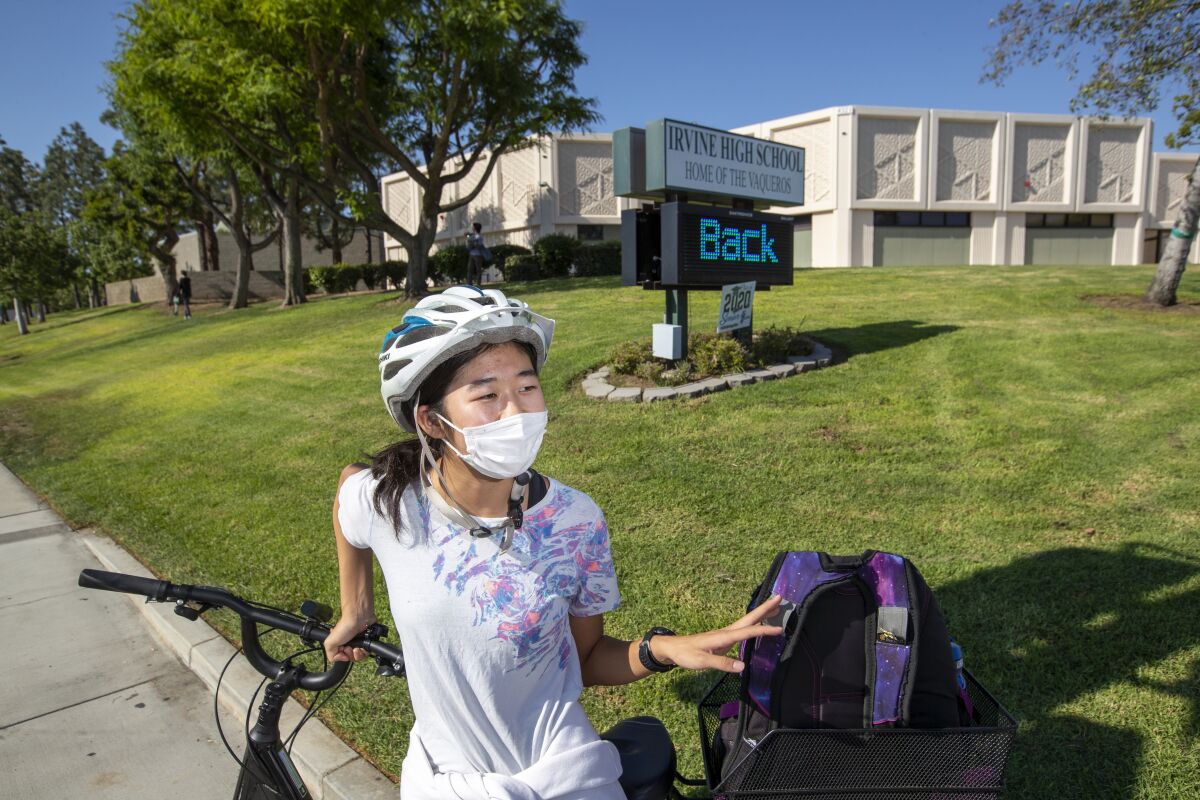 Irvine High School sophomore Ayaka Hiraki, 15, sits on her bicycle as she returns to school on Sept. 24.