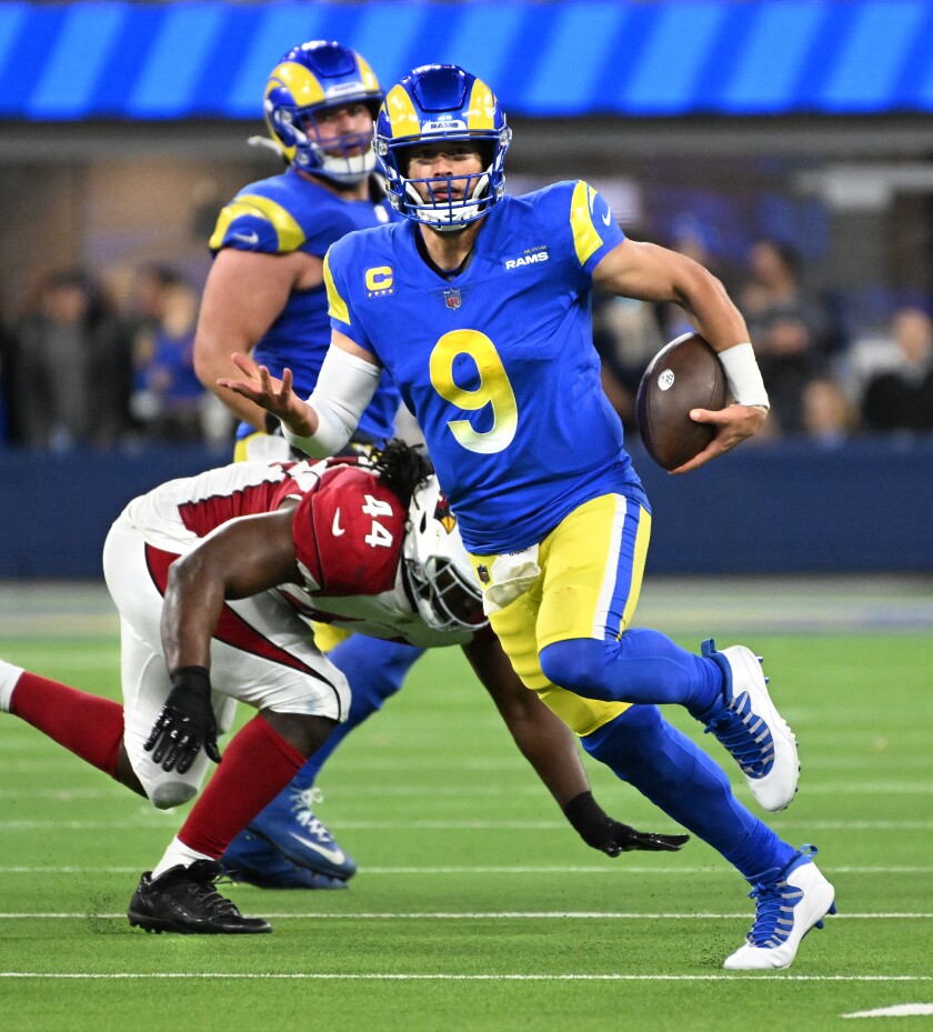 Rams quarterback Matthew Stafford scrambles for a first down against the Cardinals in their NFC wild-card playoff game.