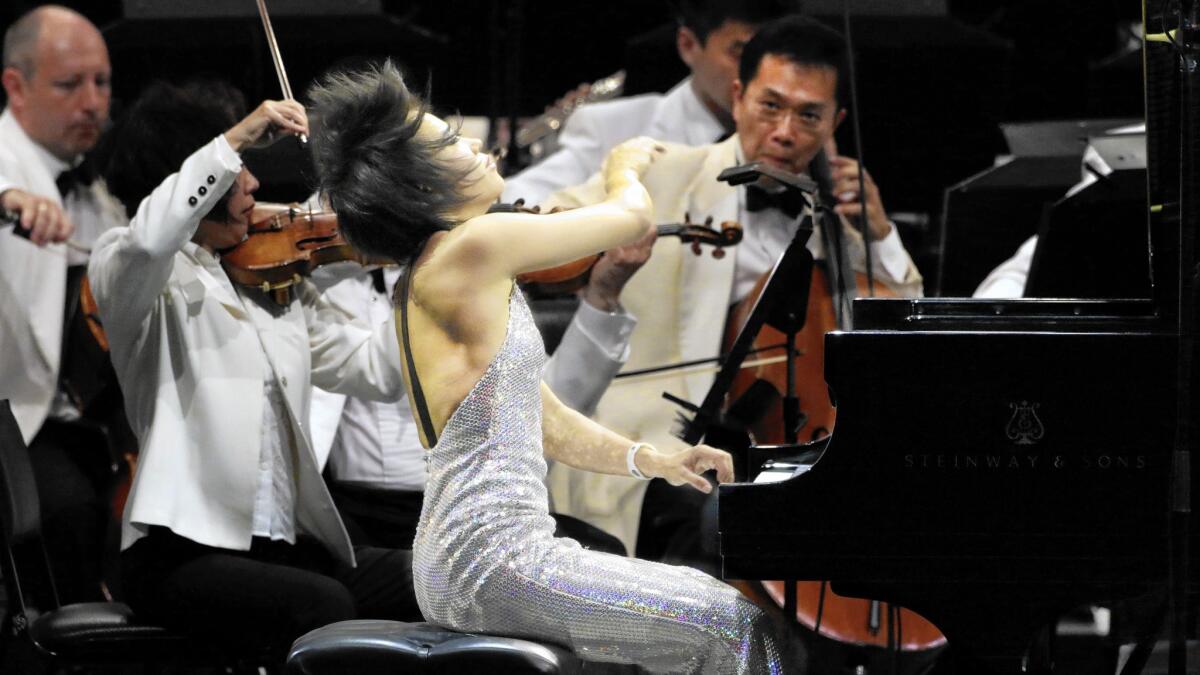 Yuja Wang returns to the Hollywood Bowl with conductor Lionel Bringuier in flamboyant form both in fashion and, more to the point, in performance.