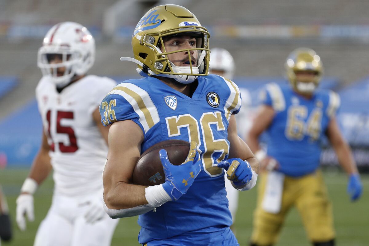 UCLA running back Ethan Fernea carries the ball during a game.
