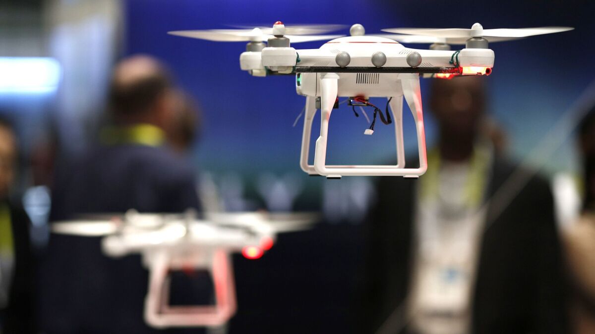 Drones fly at the CES electronics show in Las Vegas in 2015.