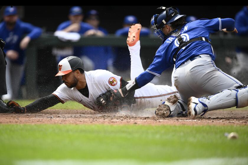 Baltimore Orioles' Anthony Santander, left, is tagged out at home by Toronto Blue Jays catcher Danny Jansen, right, during the eighth inning of a baseball game, Wednesday, May 15, 2024, in Baltimore. The Orioles won 3-2. (AP Photo/Nick Wass)