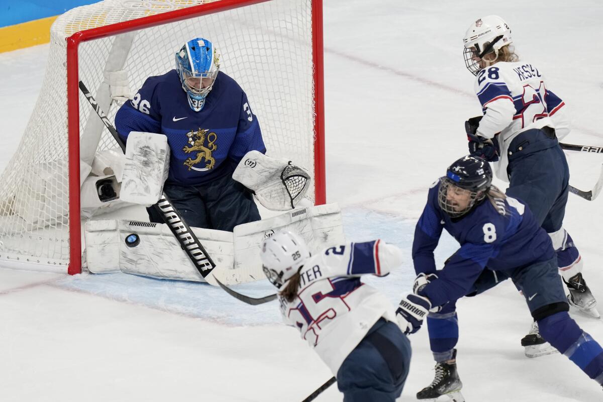 United States' Alex Carpenter scores a goal past Finland goalkeeper Anni Keisala.
