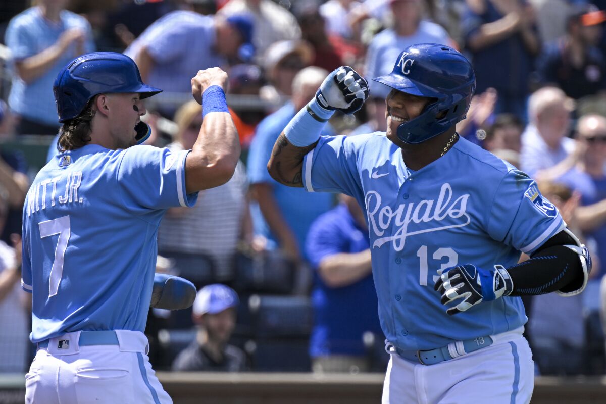 The Kansas City Royals' Salvador Perez (13) celebrates his two-run home run with teammate Bobby Witt Jr. (7) during the sixth inning of a baseball game against the Houston Astros, Sunday, June 5, 2022, in Kansas City, Mo. (AP Photo/Reed Hoffmann)