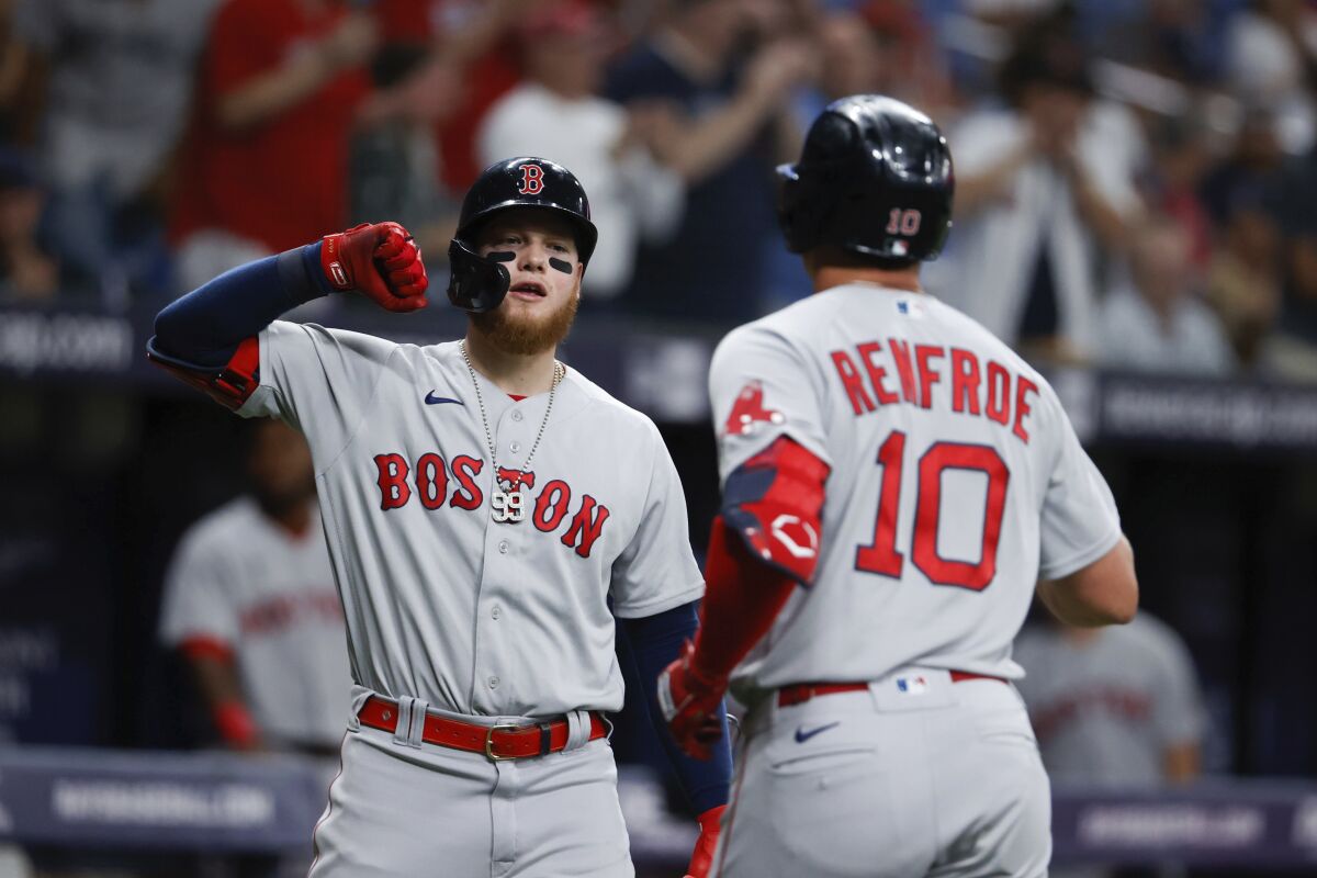 Boston Red Sox right fielder Hunter Renfroe (10) celebrates his home run against the Tampa Bay Rays with teammate Christian Vazquez (7) during the fourth inning of a baseball game, Sunday, Aug. 1, 2021, in St. Petersburg, Fla. (AP Photo/Scott Audette)