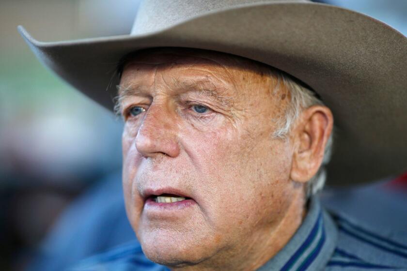 FILE - In this April 11, 2015, file photo, Nevada rancher Cliven Bundy speaks with supporters at an event in Bunkerville, Nev. Twice federal prosecutors in Las Vegas have failed to win full convictions of men who had guns during an April 2014 armed standoff with government agents trying to round up cattle belonging to Nevada rancher Cliven Bundy. Nevertheless, they're now moving to the main event, with openings expected Tuesday, Nov. 7 for a trial of the 71-year-old family patriarch and states' rights figure, his two eldest sons and one other co-defendant accused of leading a self-styled militia in an uprising against government authority.(AP Photo/John Locher, File)