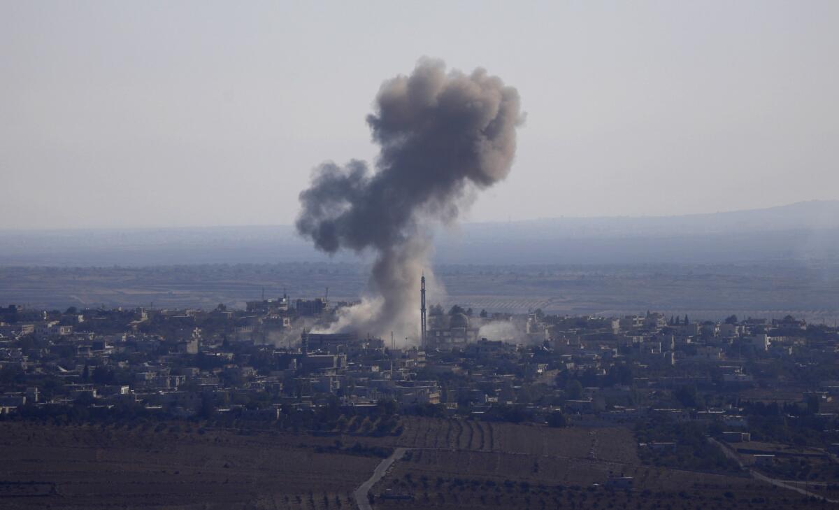 Smoke rises from the Syrian village of Jubata Khashab moments before the fighter jet that bombed the village was shot down by Israel over the Golan Heights on Sept. 23.