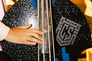 A musician plays the double bass at Los Guitarrazos