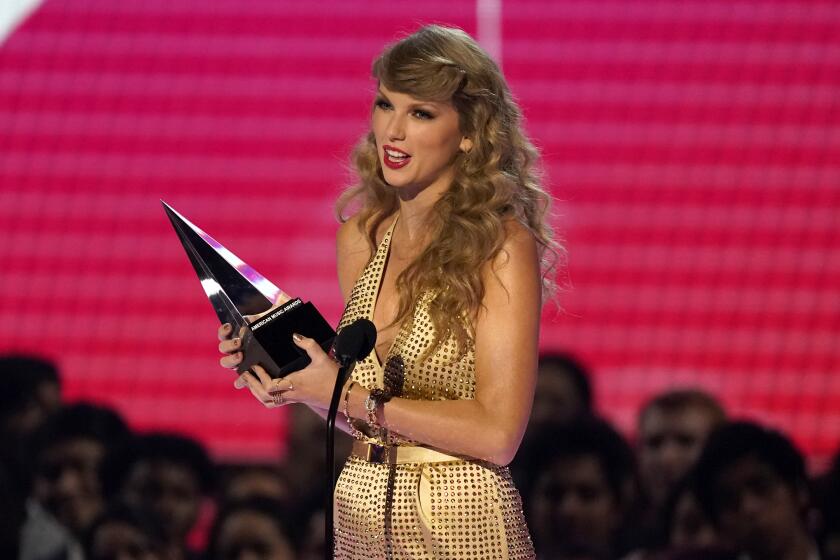 Taylor Swift accepts the award for favorite pop album for "Red (Taylor's Version)" at the American Music Awards on Sunday, Nov. 20, 2022, at the Microsoft Theater in Los Angeles. (AP Photo/Chris Pizzello)
