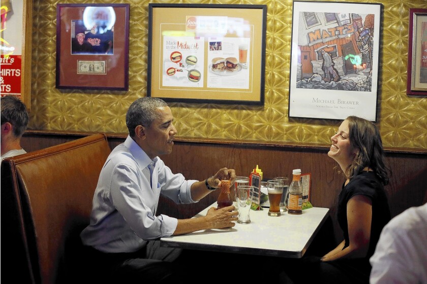 President Obama and Minnesota resident Rebekah Erler have lunch at a Minneapolis burger restaurant. Erler wrote Obama a letter in March about her struggles to pay for child care and go to school.