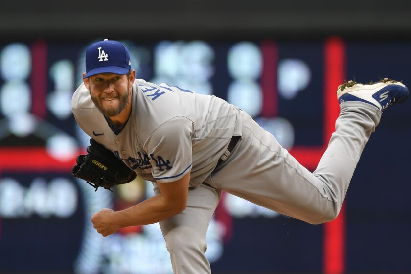 Los Angeles Dodgers pitcher Clayton Kershaw throws against the Minnesota Twins.