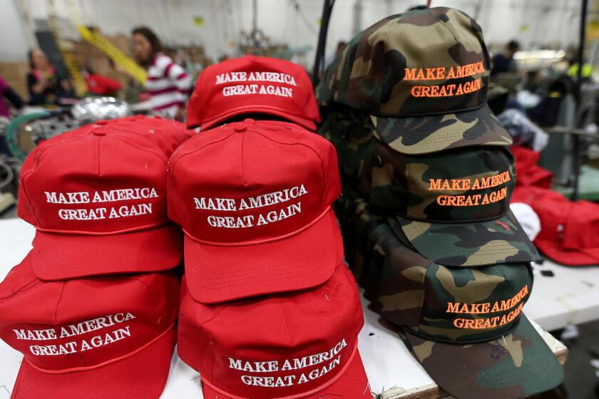 Full caption: CARSON, CALIF. NOV. 21, 2015 - Workers stitch together hats on the factory floor of Cali Fame and Cali Headwear in Carson. The hat and apparel maker is best known for producing Donald Trump’s “Make America Great Again” baseball caps.