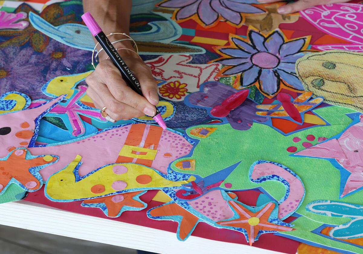 Artist C.C. Knowles adds a detail to an Attic to Art piece at her home studio in Newport Beach.