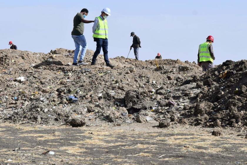 Mandatory Credit: Photo by STRINGER/EPA-EFE/REX (10153155a) Rescue workers search the site for pieces of the wreckage of an Ethiopia Airlines Boeing 737 Max 8 aircraft near Bishoftu, Ethiopia, 13 March 2019. Ethiopian Airlines flight ET 302 carrying 149 passengers and 8 crew was en route to Nairobi, Kenya, when it crashed on 10 March 2019 by yet undetermined reason. All passengers and crew aboard died in the crash. The Boeing 737 Max 8 aircraft has come under scrutiny after similar deadly crashes in Ethiopia and Indonesia within a few months. Several countries have banned the plane type from their airspace and many airlines have grounded their 737 Max 8 planes for safety concerns after the Ethiopian Airlines plane crashed minutes after take-off on 10 March. Ethiopian Airlines crash aftermath, Bishoftu, Ethiopia - 13 Mar 2019 ** Usable by LA, CT and MoD ONLY **