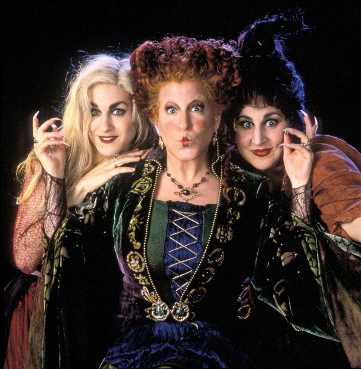 Three women in colorful witch costumes