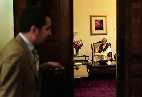 An aide to Afghan President Hamid Karzai closes the door to Karzais private offices at the presidential palace compound in Kabul, the capital.