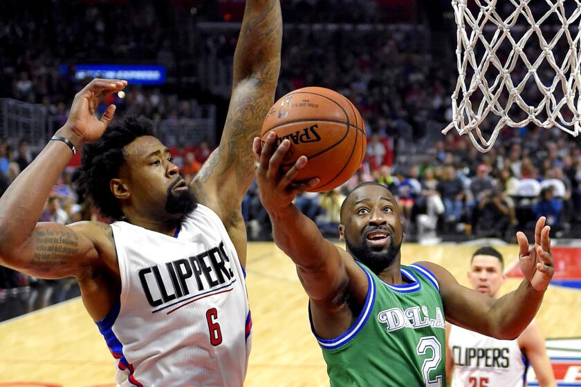 Clippers center DeAndre Jordan looks to block a layup by former Mavericks guard Raymond Felton during the first half on April 10.
