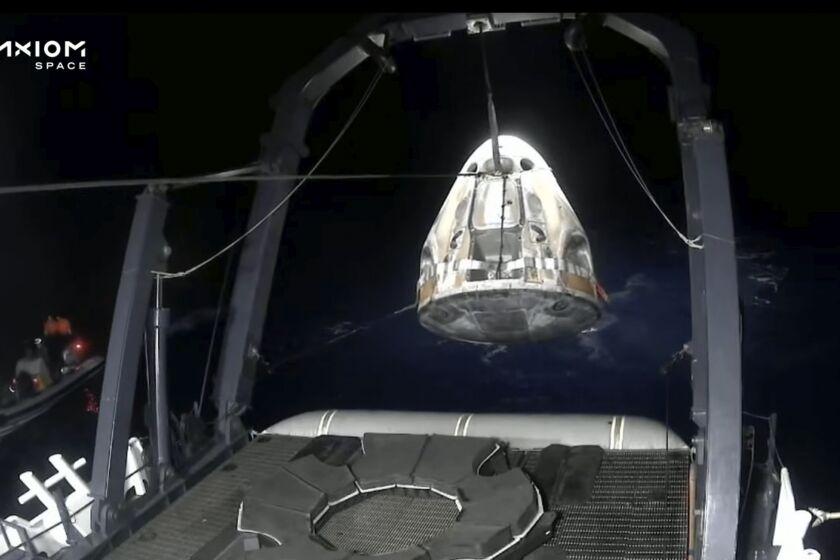 In this frame grab from video broadcast by SpaceX, recovery crews lift and secure the SpaceX Dragon capsule after it splashed down into the Gulf of Mexico, just off the Florida Panhandle, late Tuesday, May 30, 2023. The private flight carrying two Saudi astronauts and other passengers returned to Earth after a nine-day trip to the International Space Station. (SpaceX via AP)