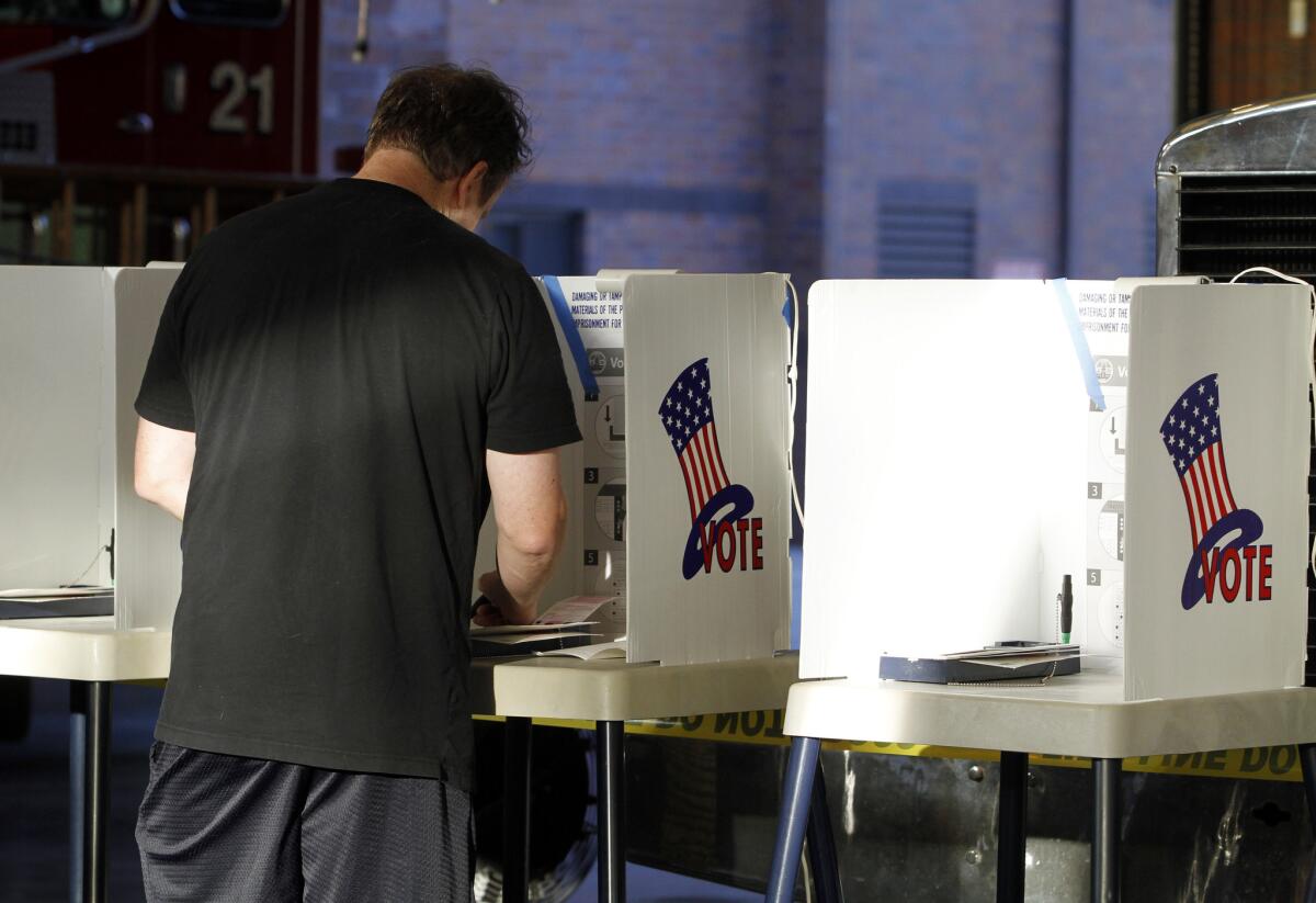 Dave Beuscher of Glendale votes at Fire Station 21 in Glendale, on Tuesday, Nov. 4, 2014.