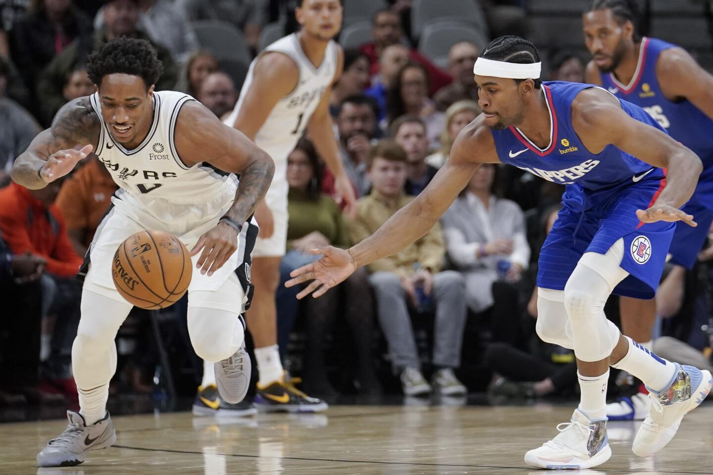 Spurs guard DeMar DeRozan and Clippers forward Maurice Harkless battle for possession of the ball during the first half a game Nov. 29.