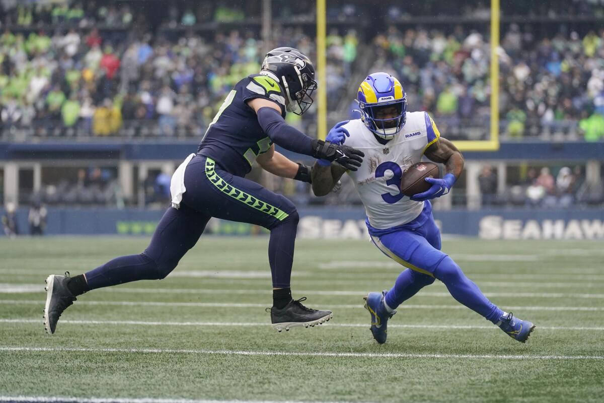Rams running back Cam Akers (3) is tackled by Seattle Seahawks linebacker Cody Barton in the first half.