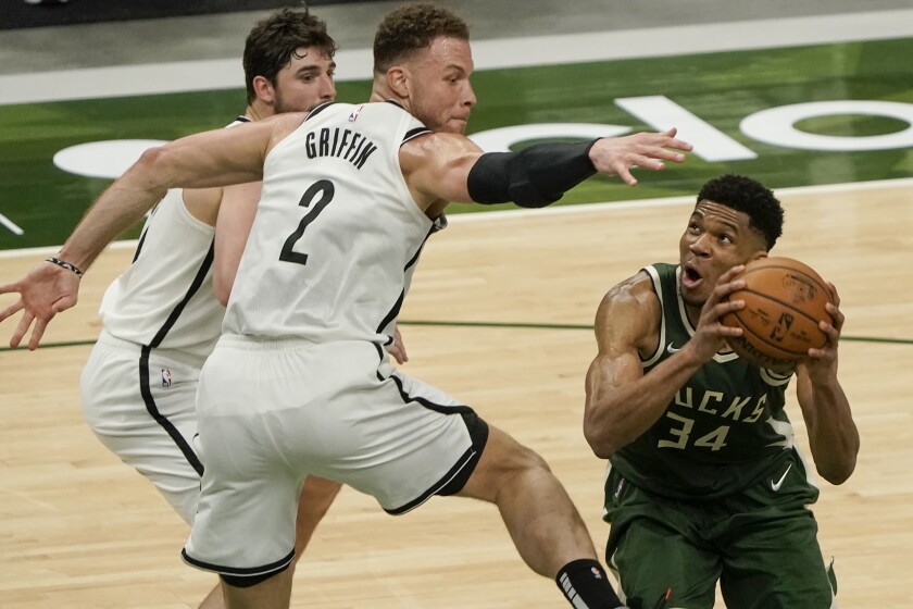 Milwaukee Bucks' Giannis Antetokounmpo shoots past Brooklyn Nets' Blake Griffin during the second half of an NBA basketball game Sunday, May 2, 2021, in Milwaukee. (AP Photo/Morry Gash)