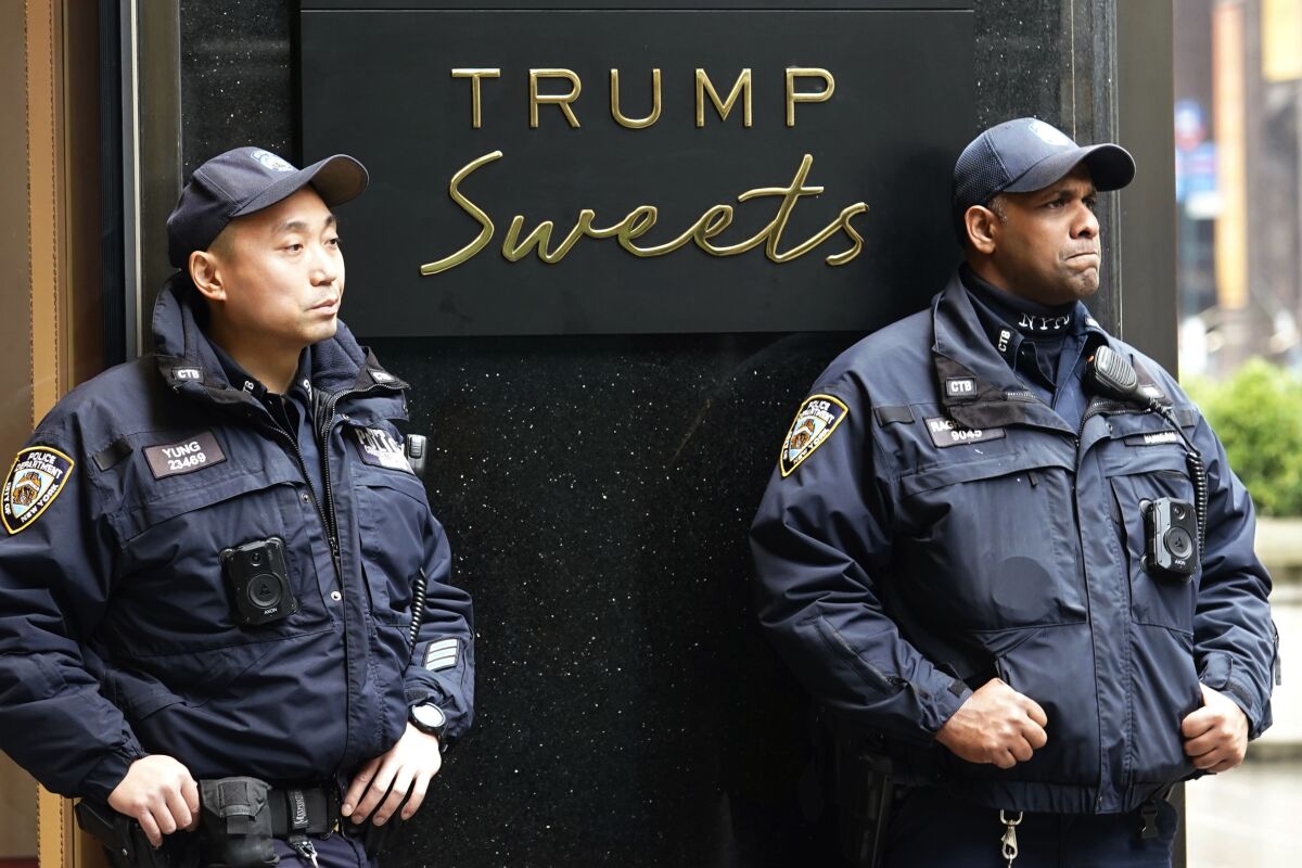 NYPD officers assigned to the Counterterrorism Bureau stand post outside of Trump Tower on Thursday , March 23, 2023, in New York. A New York grand jury investigating former President Donald Trump over a hush money payment to a porn star appears poised to complete its work soon as law enforcement officials make preparations for possible unrest in the event of an indictment. (AP Photo/Bryan Woolston)