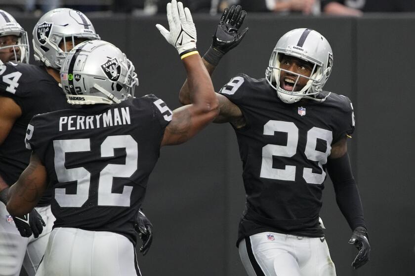 Las Vegas Raiders' Denzel Perryman, left, celebrates after cornerback Casey Hayward (29) made a safety against the Miami Dolphins during the first half of an NFL football game, Sunday, Sept. 26, 2021, in Las Vegas. (AP Photo/Rick Scuteri)